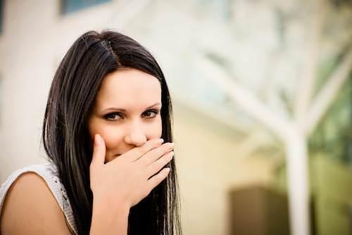 Woman hiding her teeth from camera