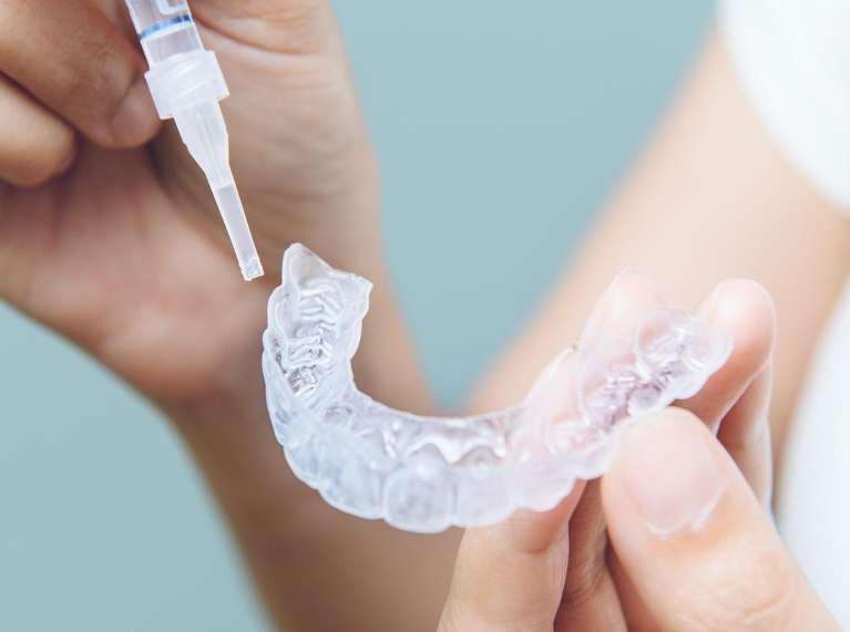 Woman holding an Invisalign