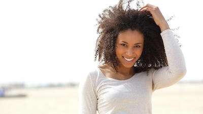 woman holding her curly hair